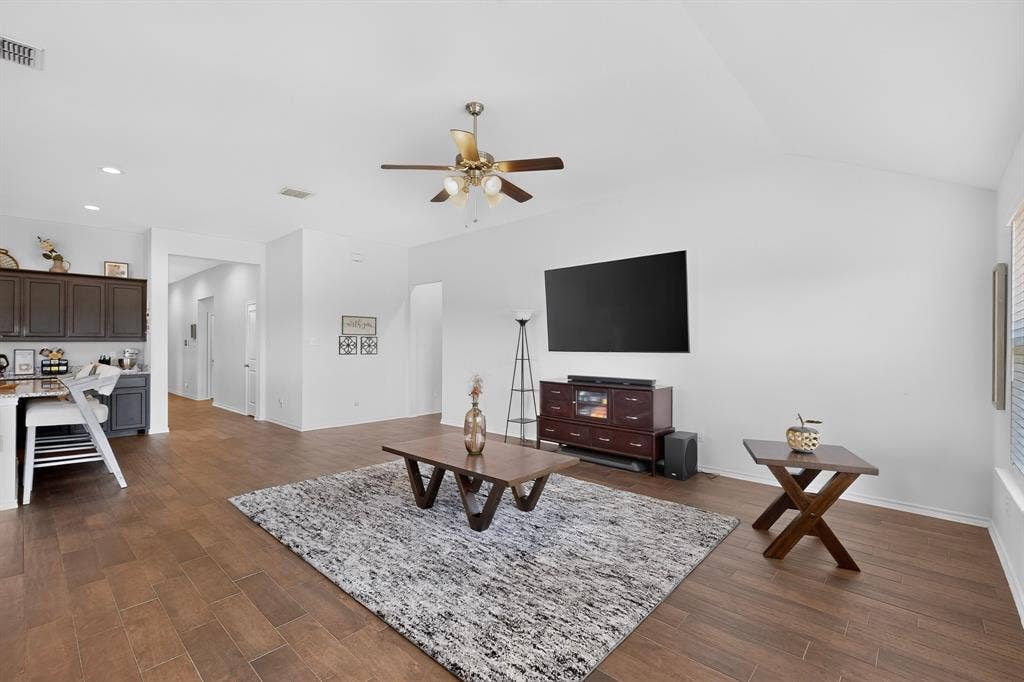 11700 Aldermoor Court, Fort Worth, TX 76036 Vaulted ceiling with a ceiling fan, recessed lighting, wood-finish flooring, and dark cabinetry