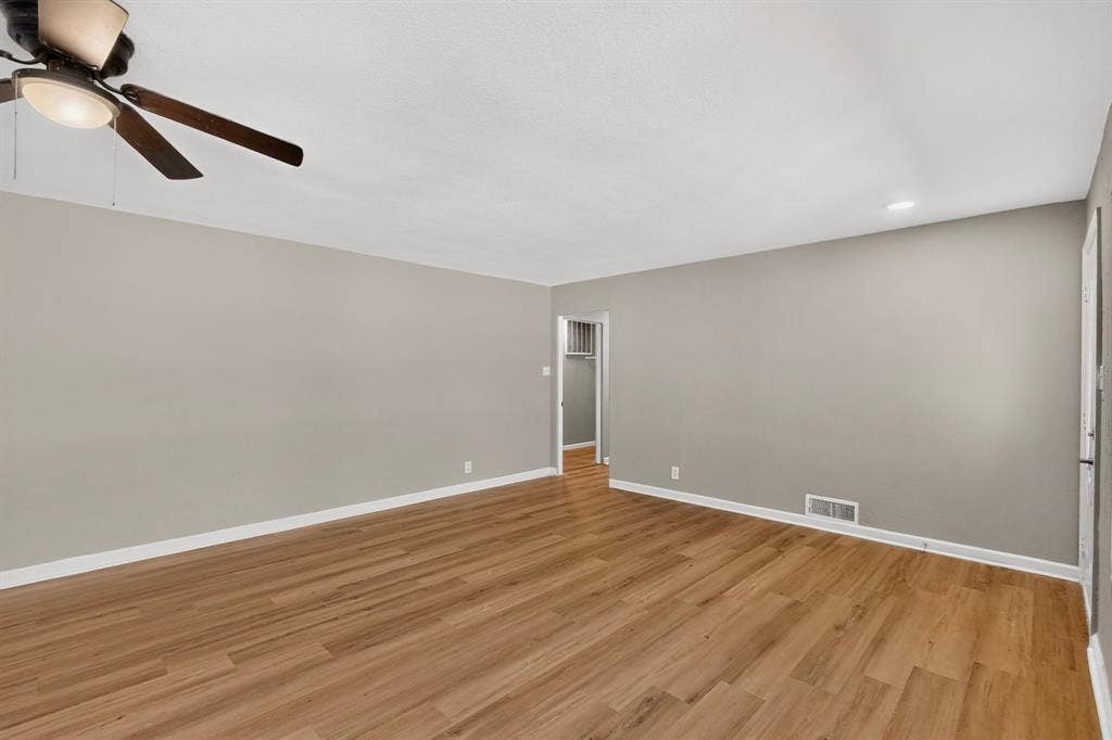 2314 Wales Place, Irving, TX 75062 Wood-finish flooring, neutral gray wall tones, ceiling fan with integrated lighting, and recessed lighting