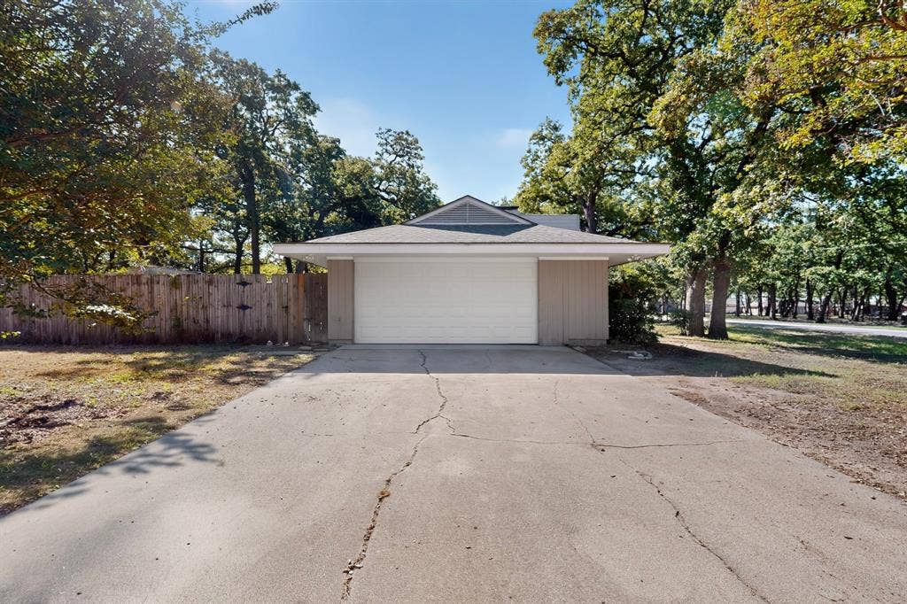 2314 Wales Place, Irving, TX 75062 Attached garage with a white overhead door