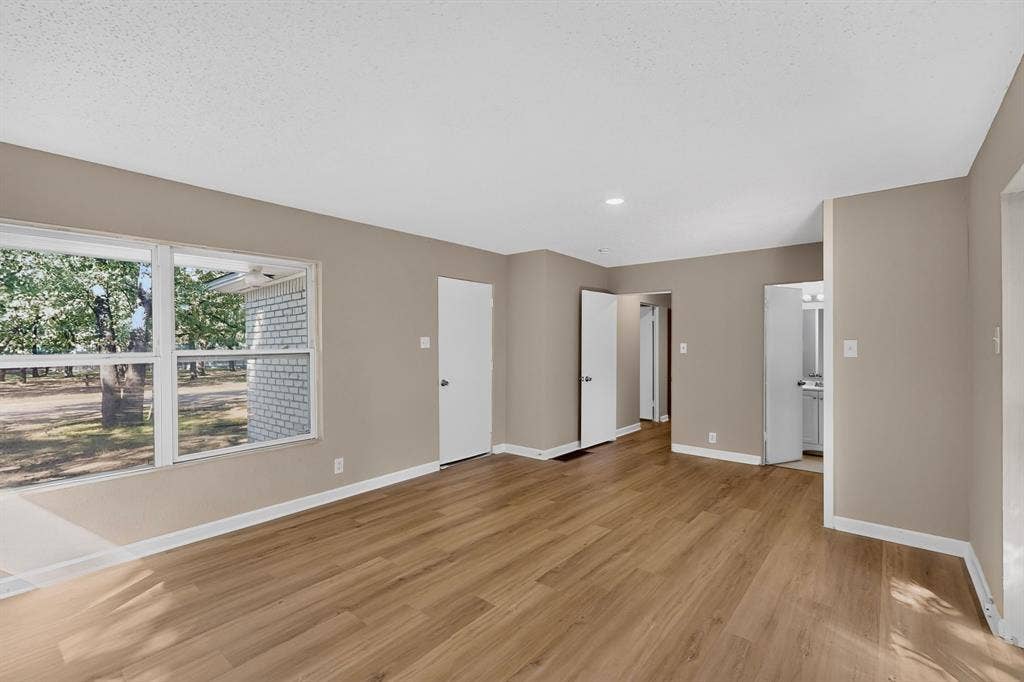 2314 Wales Place, Irving, TX 75062 Wood-finish flooring, recessed lighting, neutral wall tones, and white trim throughout