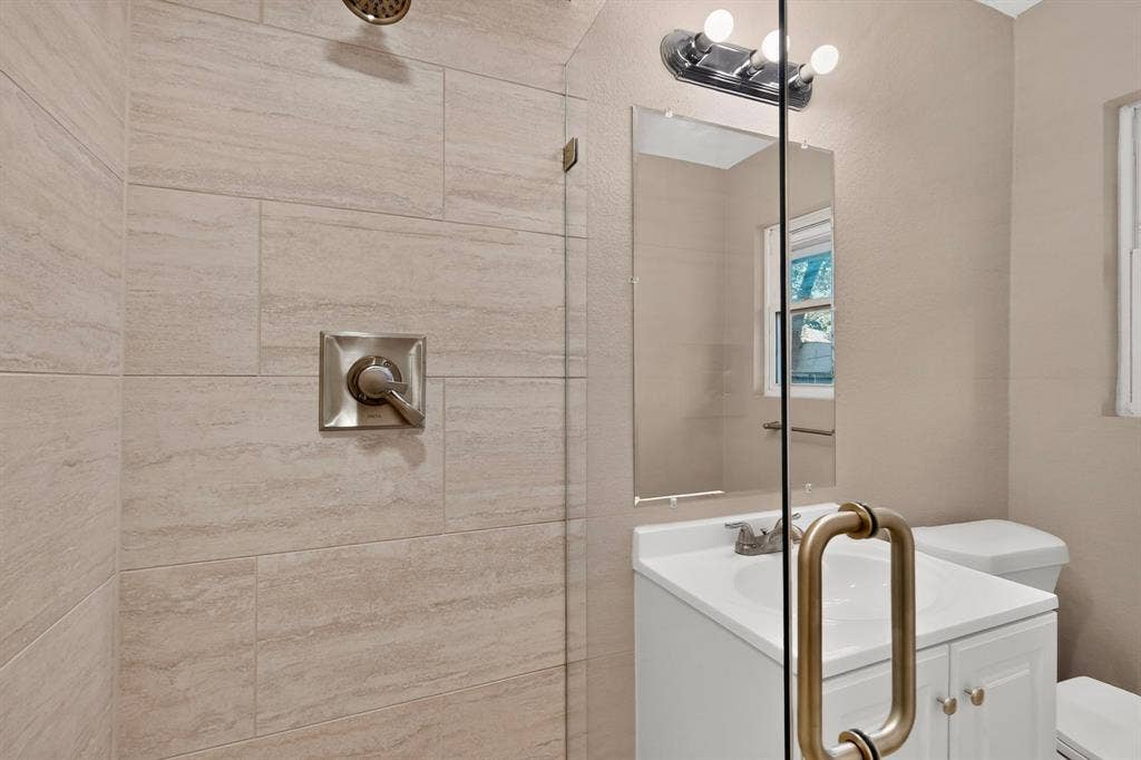 2314 Wales Place, Irving, TX 75062 Glass-enclosed shower with large format wall tiling and brushed nickel fixtures