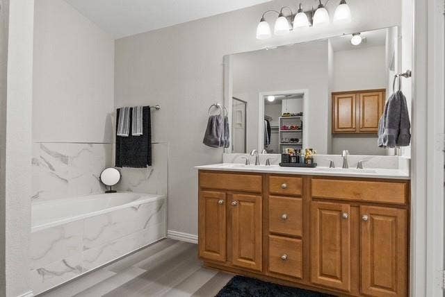 7944 Eddie Drive, Plano, TX 75025 Dual vanity with wood cabinetry, large vanity mirror, white countertop, and contemporary light fixture