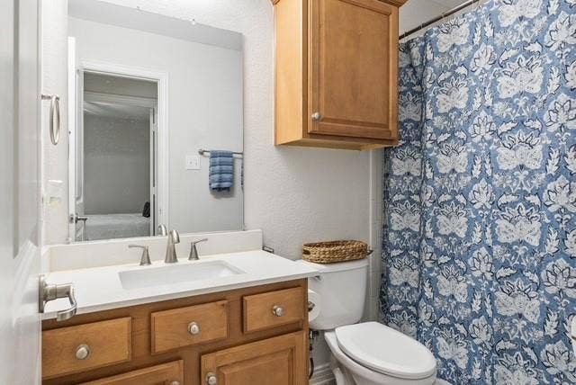 7944 Eddie Drive, Plano, TX 75025 Vanity with a built-in sink, brushed nickel faucet, and wood-finish cabinetry
