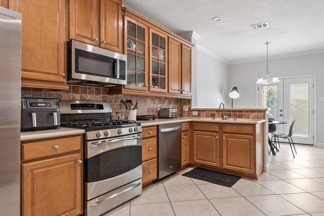 7944 Eddie Drive, Plano, TX 75025 Kitchen featuring wood cabinetry, stainless steel appliances, tile flooring, and a tile backsplash