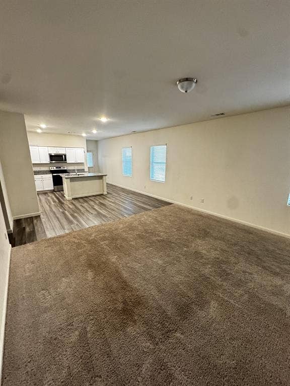 1813 Chapel Hill Road, Princeton, TX 75407 Open-concept living area with neutral carpeting