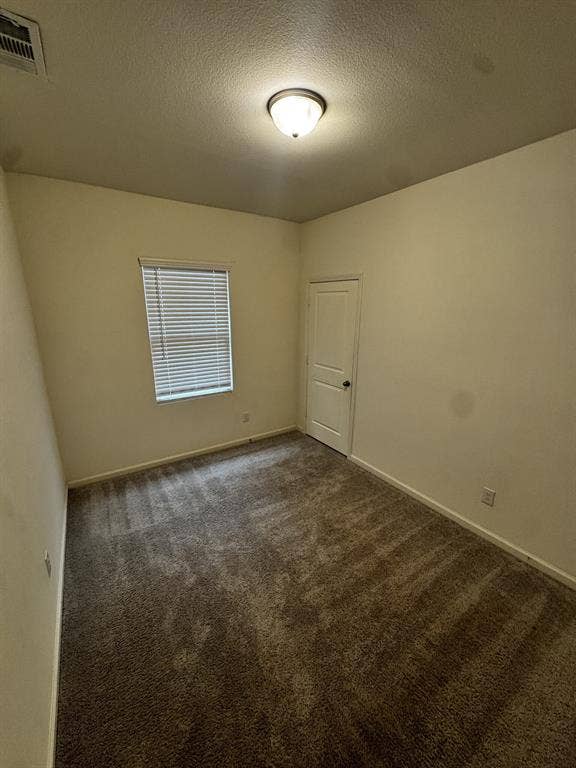 1813 Chapel Hill Road, Princeton, TX 75407 Neutral tone wall paint with a textured ceiling finish, recessed window with blinds, and flush-mount ceiling light