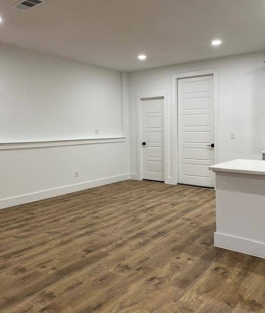 9473 Timberleaf Drive, Dallas, TX 75243 Wood-finish flooring, recessed lighting, white panel doors, and a partial countertop with light-toned surface