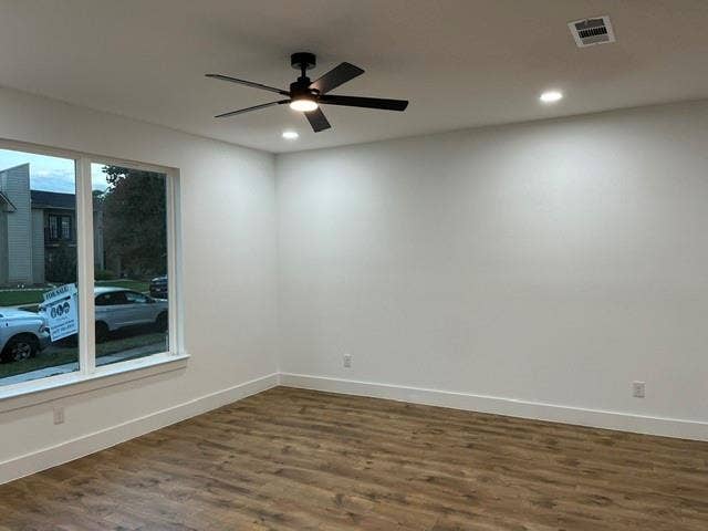 9473 Timberleaf Drive, Dallas, TX 75243 Wood-finish flooring, white walls, and a large window