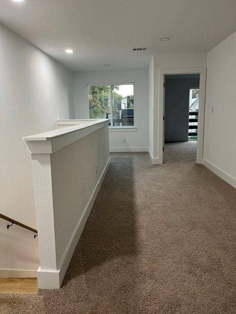 9473 Timberleaf Drive, Dallas, TX 75243 Carpeted hallway featuring a window, recessed lighting, and white trim
