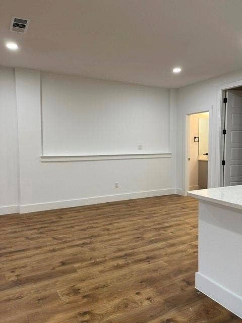 9473 Timberleaf Drive, Dallas, TX 75243 Recessed lighting, wood-finish flooring, white walls, white trim, and a partial white countertop