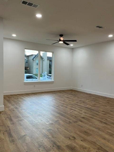 9473 Timberleaf Drive, Dallas, TX 75243 Wood-finish flooring, recessed lighting, ceiling fan, white trim, and a window