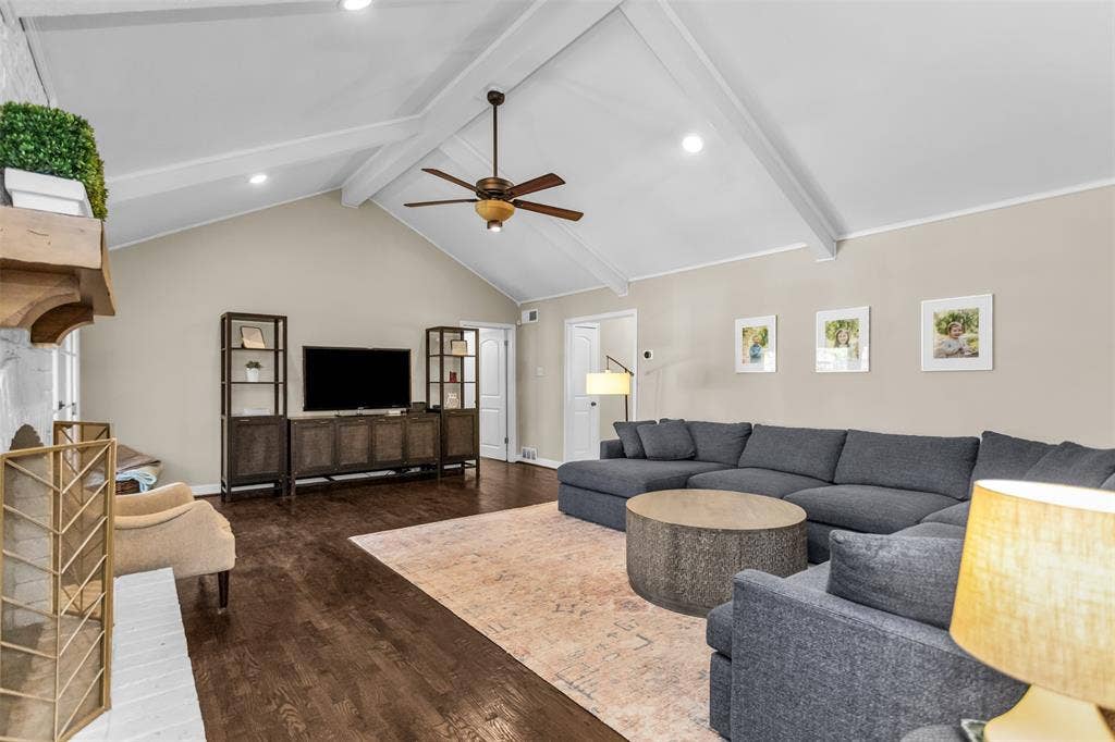 Vaulted ceiling with exposed beams, recessed lighting, ceiling fan, and wood-finish flooring