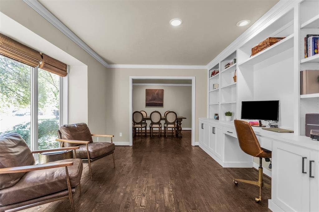 Sophisticated living space currently used as an office.   Loads of light from the huge front window. Extensive built-in cabinetry.  Views of pretty neighborhood.