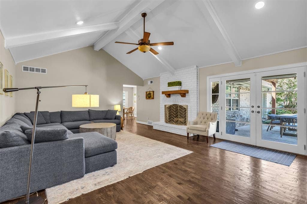 Expansive open-concept living area featuring cathedral ceilings, recessed lighting, gas fireplace.  Overlooks the patio, pool and lawn.