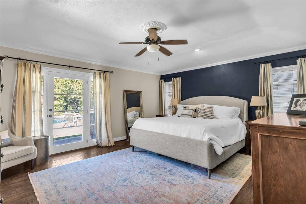 Spacious primary bedroom.  Lovely view and access to backyard and pool.