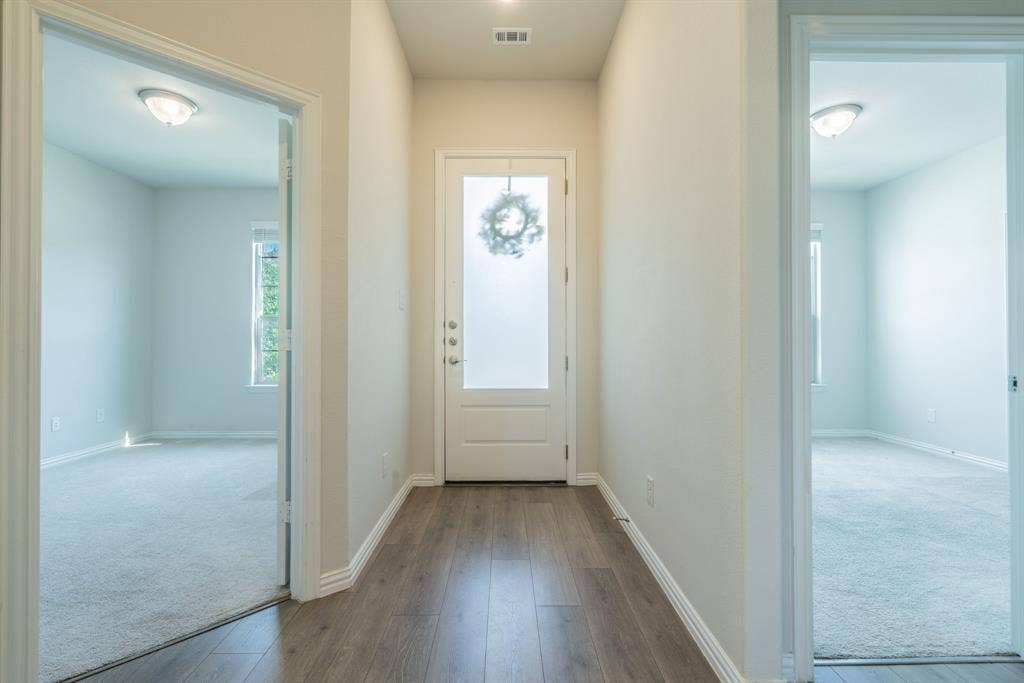 Entry way to open living area with bedrooms on either side