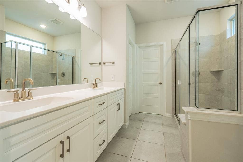 Double sinks, lots of counter space,  and luxurious shower with large walk-in closet.