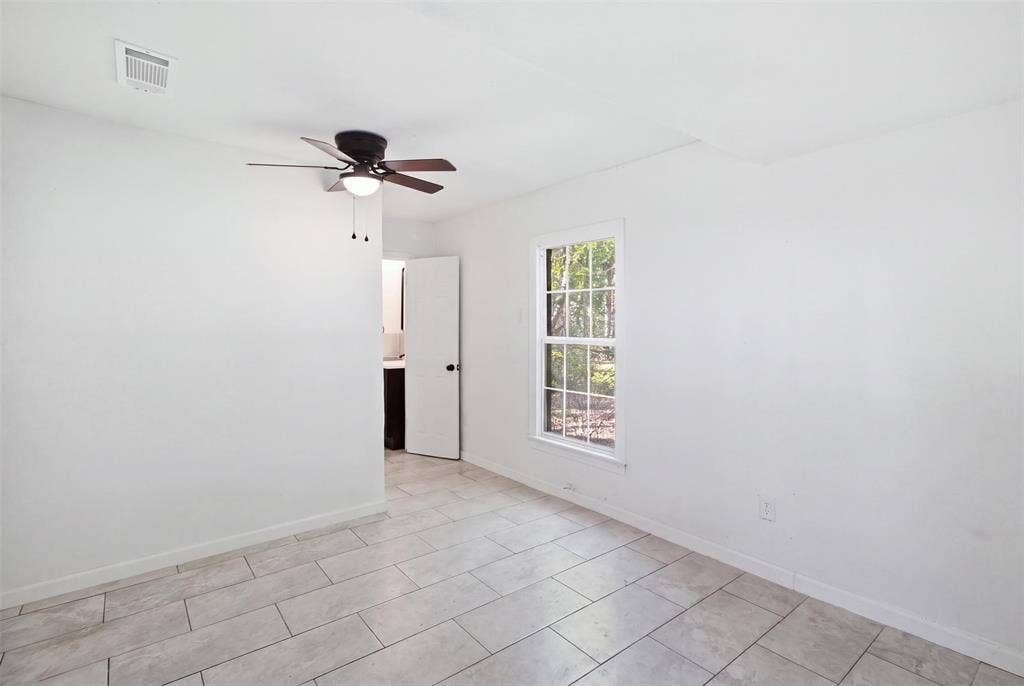 1105 Bell Drive, Greenville, TX 75401 Tile flooring, ceiling fan with integrated lighting, and a single-pane window