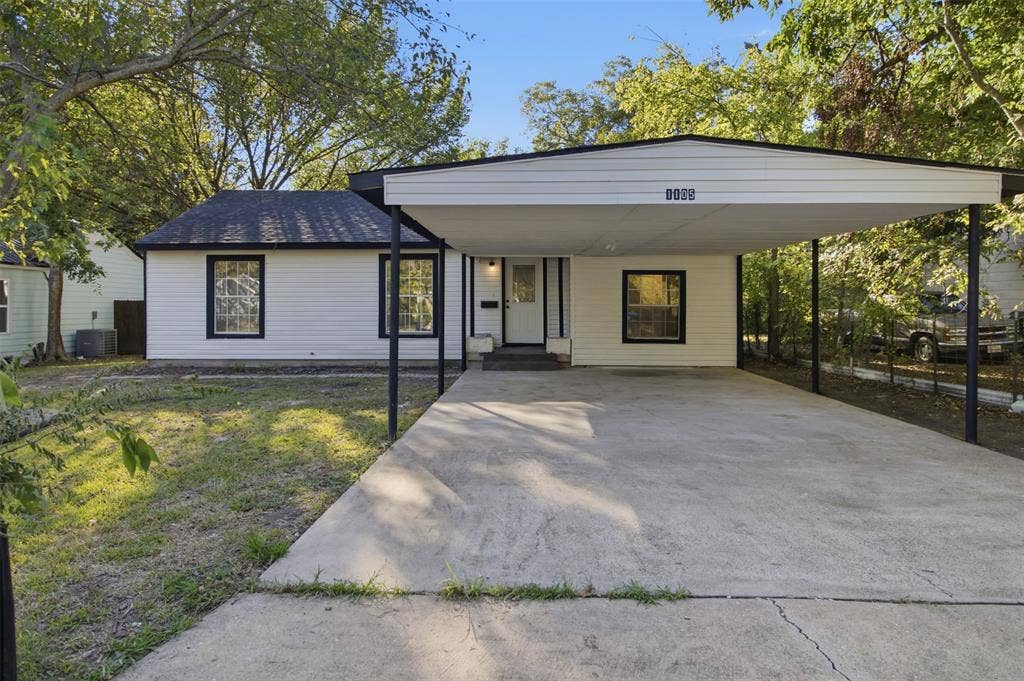 1105 Bell Drive, Greenville, TX 75401 White exterior siding with black trim windows