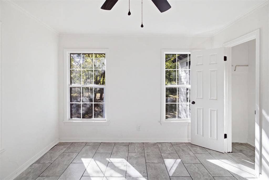 1105 Bell Drive, Greenville, TX 75401 Tile flooring, two multi-pane windows, ceiling fan, and crown molding