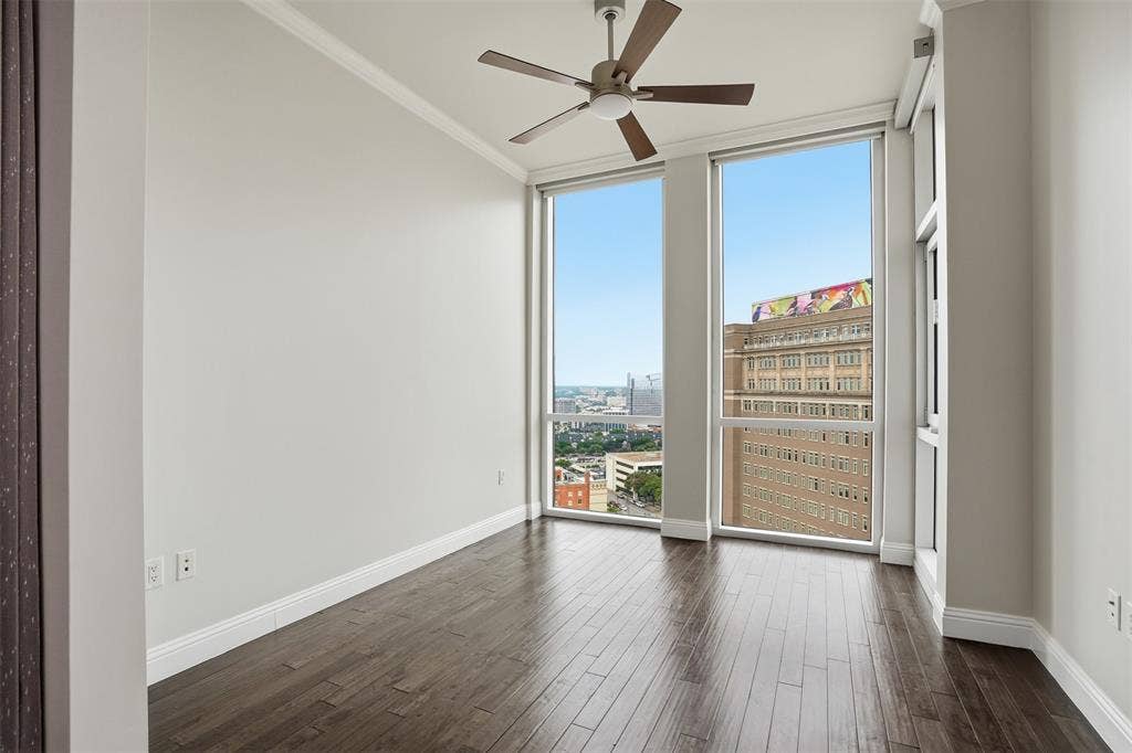 500 Throckmorton Street, #1605, Fort Worth, TX 76102 Dark wood-finish flooring with floor-to-ceiling windows, a ceiling fan, and white crown molding