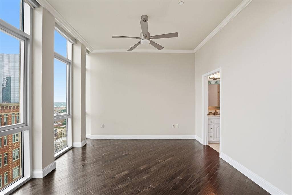 500 Throckmorton Street, #1605, Fort Worth, TX 76102 Dark wood-finish flooring, full-height windows, a ceiling fan, and crown molding