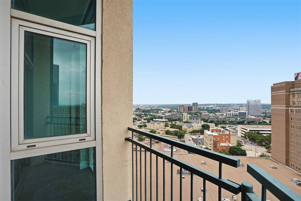 500 Throckmorton Street, #1605, Fort Worth, TX 76102 Balcony with metal railings, offering an urban skyline
