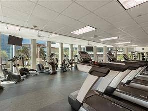 500 Throckmorton Street, #1605, Fort Worth, TX 76102 Fitness center with expansive window walls, ceiling-mounted televisions, and recessed lighting