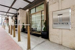 500 Throckmorton Street, #1605, Fort Worth, TX 76102 The Tower Entrance entrance featuring a metal awning, glass entry doors, and a stone facade