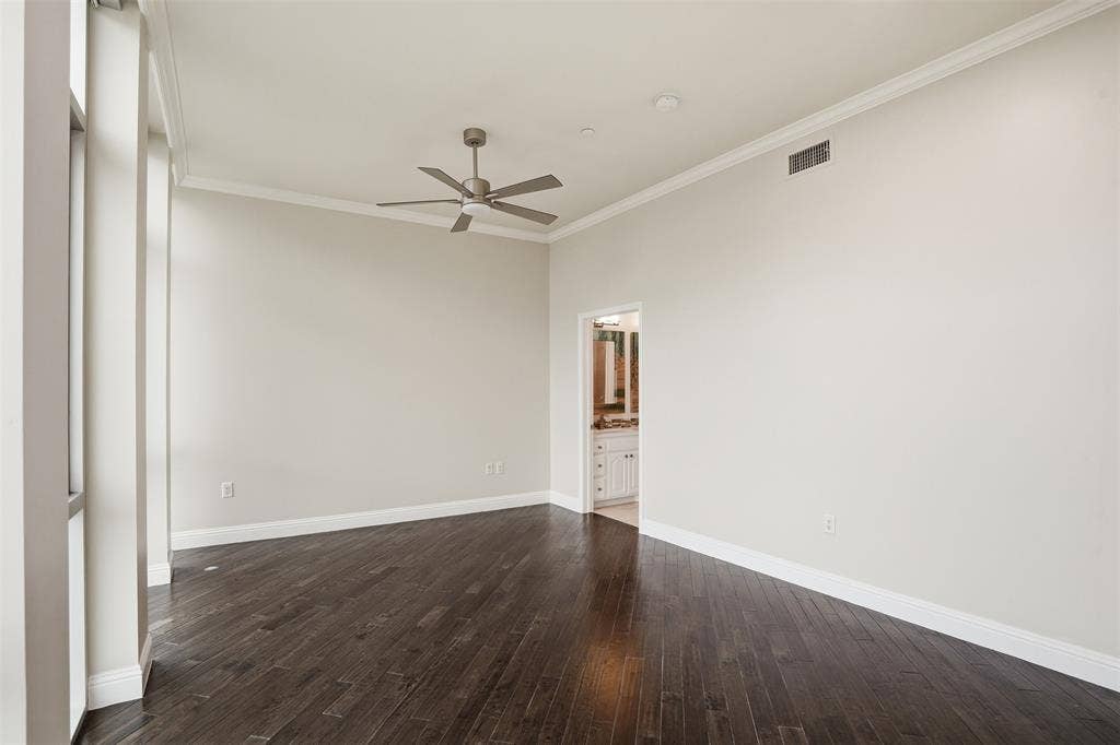 500 Throckmorton Street, #1605, Fort Worth, TX 76102 Expansive interior featuring dark wood-finish flooring, tall windows, a ceiling fan, and crown molding