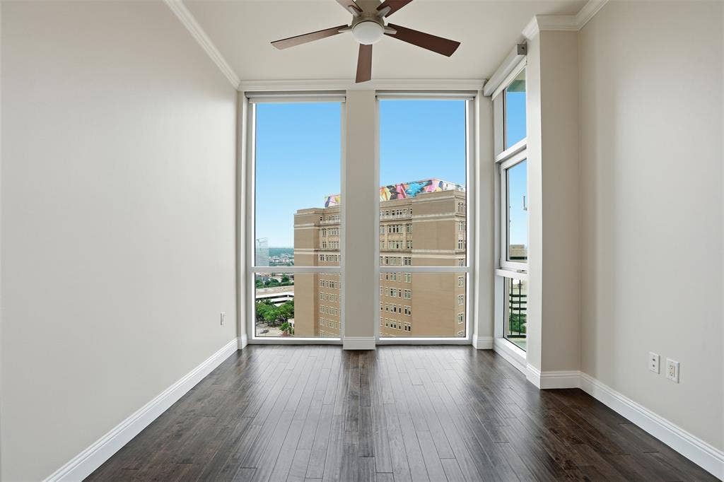500 Throckmorton Street, #1605, Fort Worth, TX 76102 Expansive windows providing abundant natural light, crown molding, wood-finish flooring, and a ceiling fan