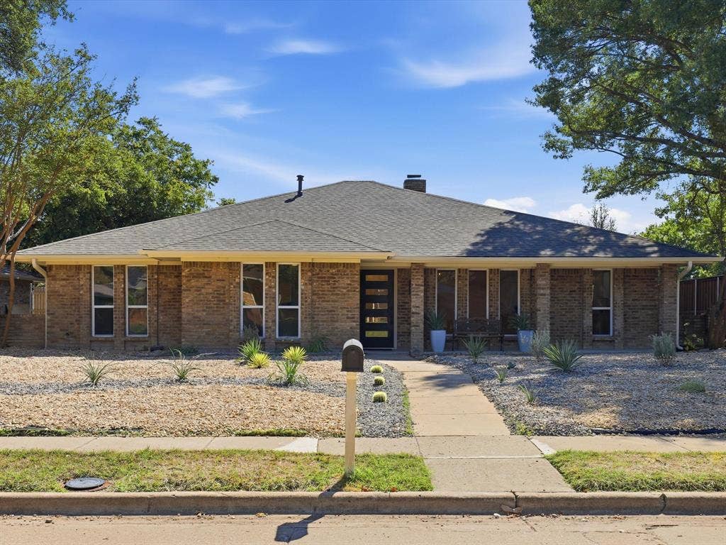 2500 Teakwood Lane, Plano, TX 75075 Brick exterior with a dark-pitched roof