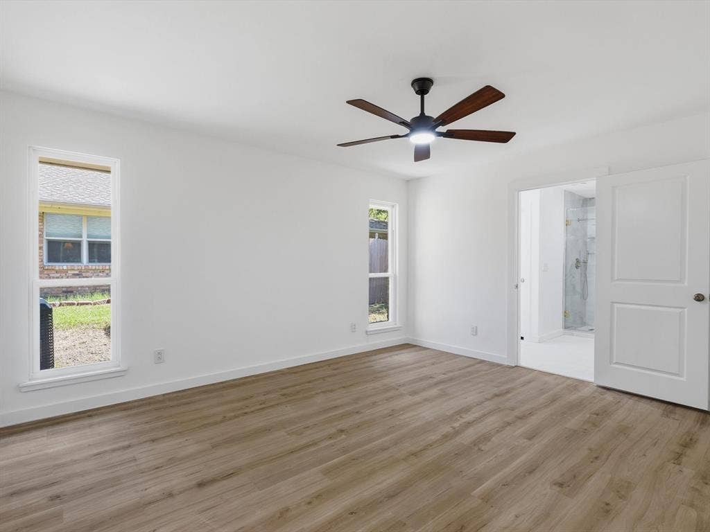 2500 Teakwood Lane, Plano, TX 75075 Spacious room featuring wood-finish flooring, white walls, and a ceiling fan with integrated lighting