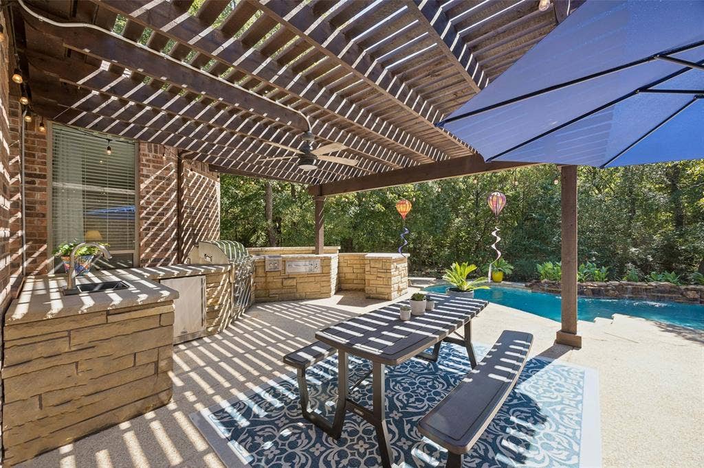 Custom Outdoor Kitchen fully equipped with Lynx grill,cooktop,warming drawer, fridge, sink, space for a smoker