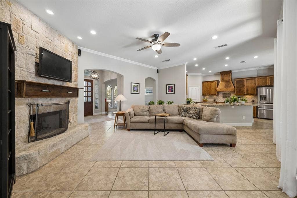 Austin Stone woodburning fireplace anchors the living room