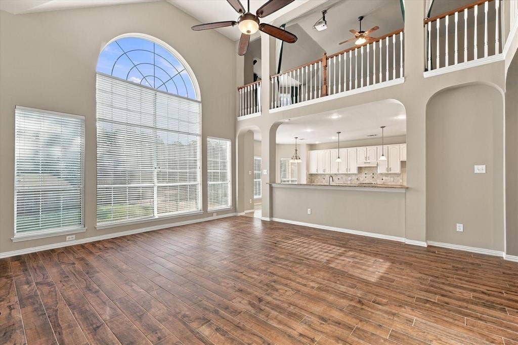 2412 Clearwood Lane, Flower Mound, TX 75028 THE PERFECT BLEND OF DRAMA AND FUNCTION! A magnificent arched window floods the impressive two-story living room with natural light, while the open kitchen overlooks the main gathering space. Architectural elegance and effortless flow create a truly remarkable setting.