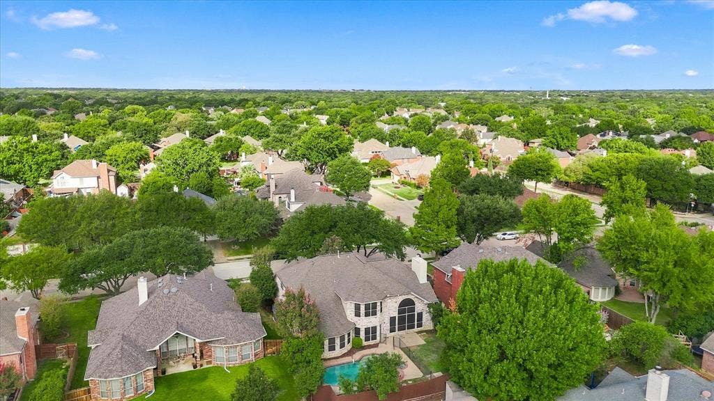 2412 Clearwood Lane, Flower Mound, TX 75028 LOCATION, BEAUTY, AND NEIGHBORHOOD CHARM! A spectacular panoramic view reveals a canopy of mature trees, beautiful established homes, and the inviting character of this Flower Mound neighborhood.