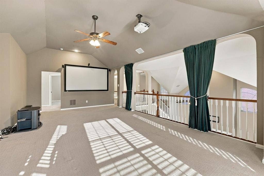 2412 Clearwood Lane, Flower Mound, TX 75028 THE ULTIMATE ENTERTAINMENT DESTINATION! A dramatic vaulted ceiling, impressive projection screen, and open balcony overlooking the living spaces below make this versatile upstairs retreat ideal for movie nights, entertaining, and relaxing in style.