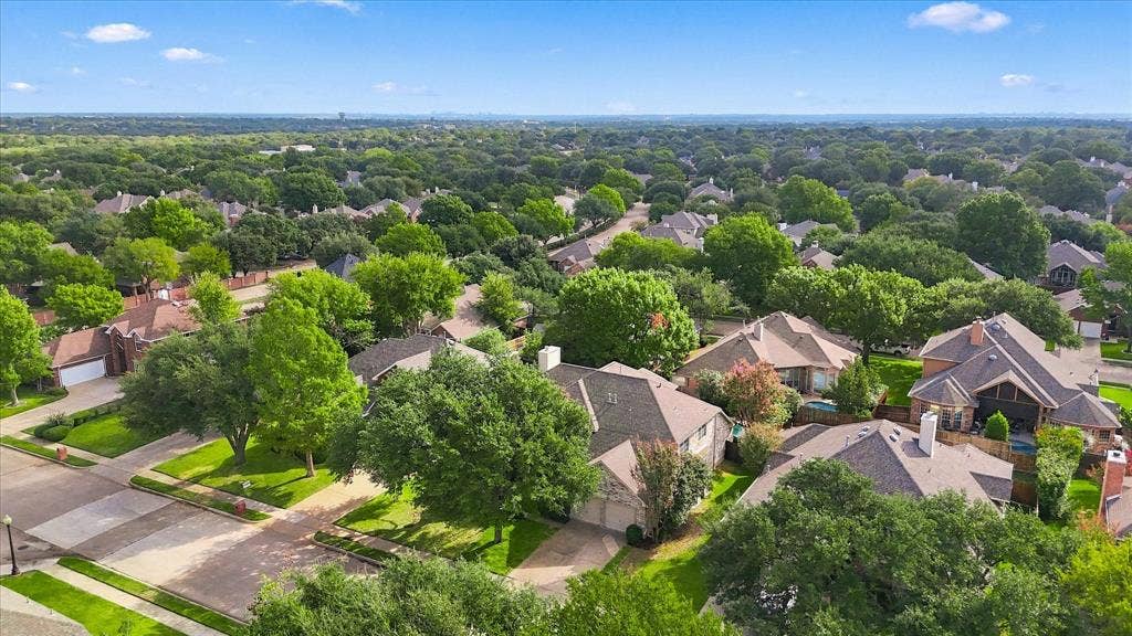 2412 Clearwood Lane, Flower Mound, TX 75028 AN EXCEPTIONAL FLOWER MOUND SETTING! Sweeping aerial views showcase an established neighborhood filled with beautiful homes, mature trees, and lush greenery, creating an inviting residential landscape.