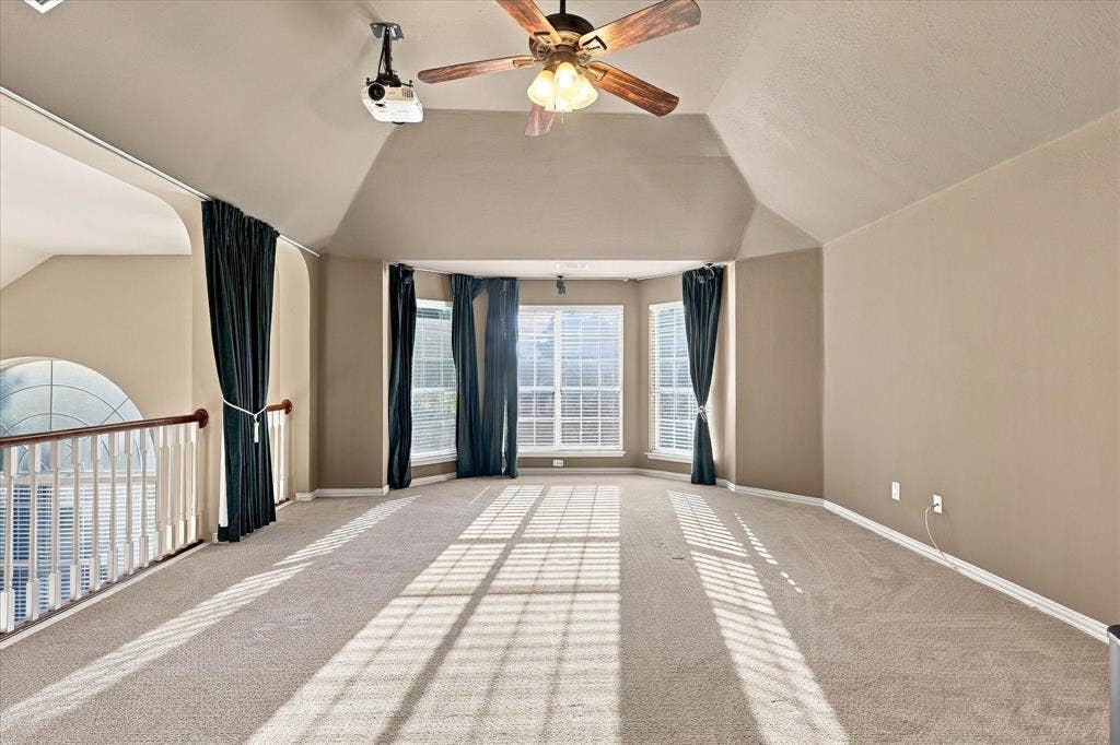 2412 Clearwood Lane, Flower Mound, TX 75028 ENTERTAINMENT POSSIBILITIES ARE ENDLESS! This impressive upstairs retreat features vaulted ceilings, fresh paint, a spacious open layout, a ceiling-mounted projector, and walls of windows that flood the room with natural light.
