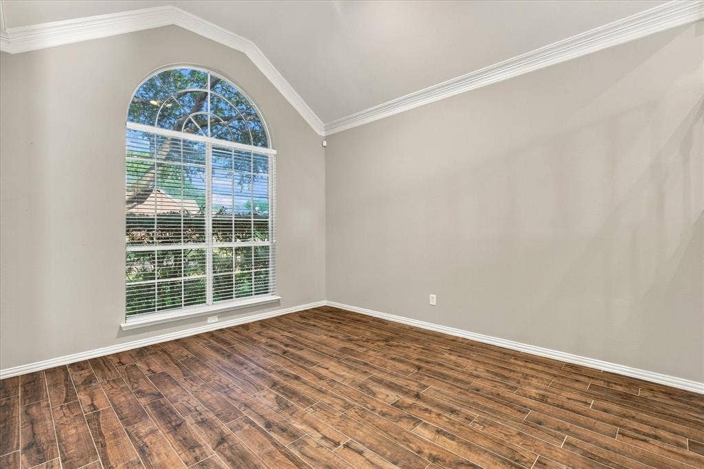 2412 Clearwood Lane, Flower Mound, TX 75028 SOPHISTICATION IN EVERY DETAIL! A magnificent arched window, soaring ceiling, beautiful crown molding, and rich wood-look tile flooring create an elegant setting for refined entertaining, intimate conversations, or a wonderful home office.