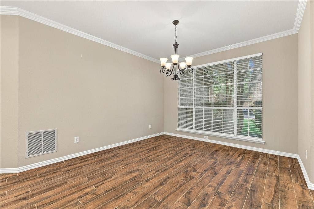 2412 Clearwood Lane, Flower Mound, TX 75028 WHERE UNFORGETTABLE GATHERINGS BEGIN! This spacious formal dining room offers timeless elegance with gorgeous flooring, graceful crown molding, a classic chandelier, and an expansive window overlooking the mature landscaping.