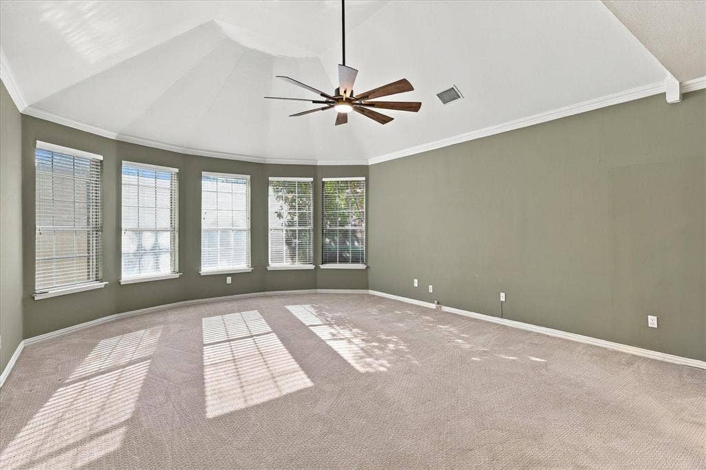 2412 Clearwood Lane, Flower Mound, TX 75028 YOUR PRIVATE SANCTUARY AWAITS! This extraordinary primary bedroom features a dramatic vaulted ceiling, an elegant bay of five windows, a statement ceiling fan, and expansive proportions. A tranquil retreat designed for ultimate comfort and relaxation.