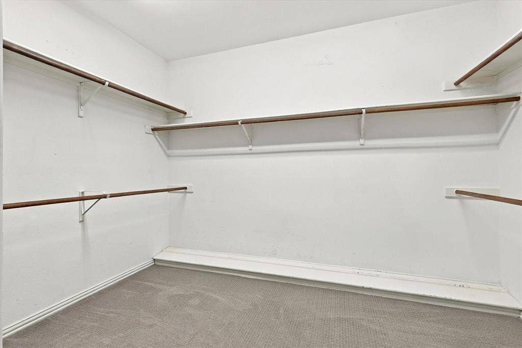 2412 Clearwood Lane, Flower Mound, TX 75028 ROOM FOR A BEAUTIFULLY ORGANIZED WARDROBE! This spacious walk-in closet offers multiple hanging areas, convenient shelving, and generous storage possibilities to keep everything beautifully arranged.