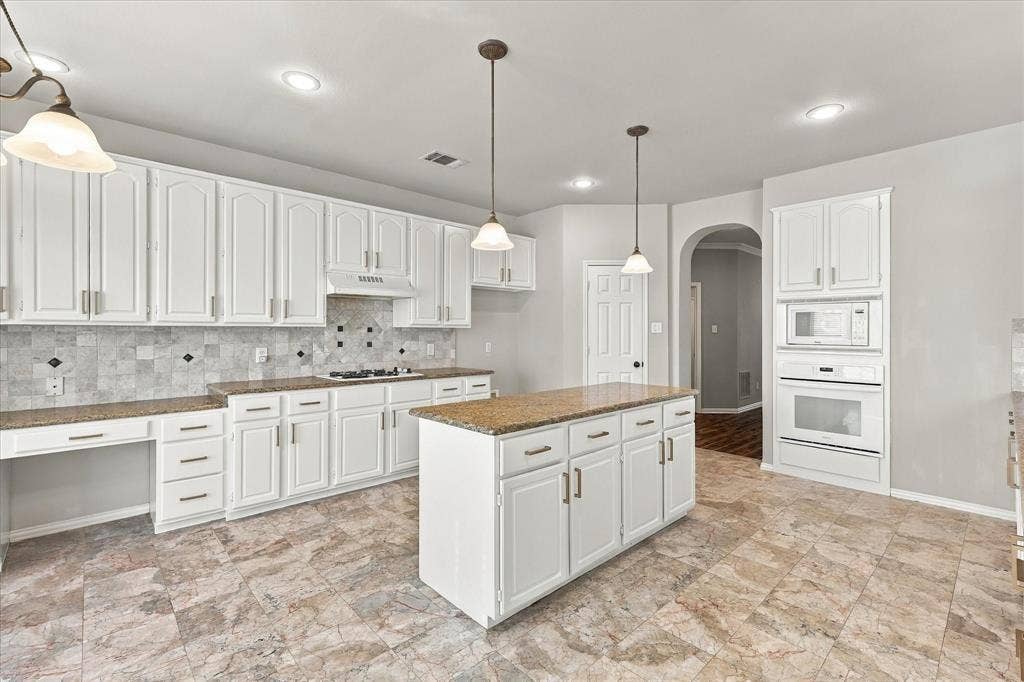 2412 Clearwood Lane, Flower Mound, TX 75028 SPACE, STYLE, AND ENDLESS POTENTIAL! An expansive center island, abundant freshly paint white cabinetry, generous preparation space, and built-in appliances make this impressive kitchen ideal for everyday cooking and entertaining. Its open design keeps everyone connected to the home's spectacular living spaces.