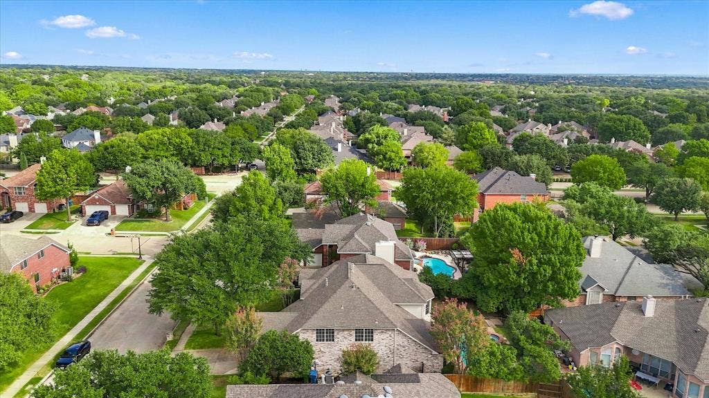 2412 Clearwood Lane, Flower Mound, TX 75028 BEAUTY FROM EVERY ANGLE! Discover the charm of this tree-lined Flower Mound community from above, showcasing attractive homes, established landscaping, and an abundance of mature greenery.