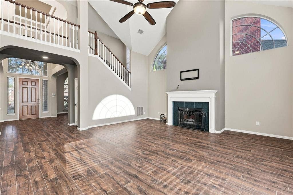 2412 Clearwood Lane, Flower Mound, TX 75028 AN ABSOLUTE ARCHITECTURAL SHOWSTOPPER! Soaring ceilings, dramatic arched windows, an elegant fireplace, and a sweeping second-story overlook make this spectacular living room the centerpiece of the home. Rich flooring and abundant natural light create a truly unforgettable atmosphere.