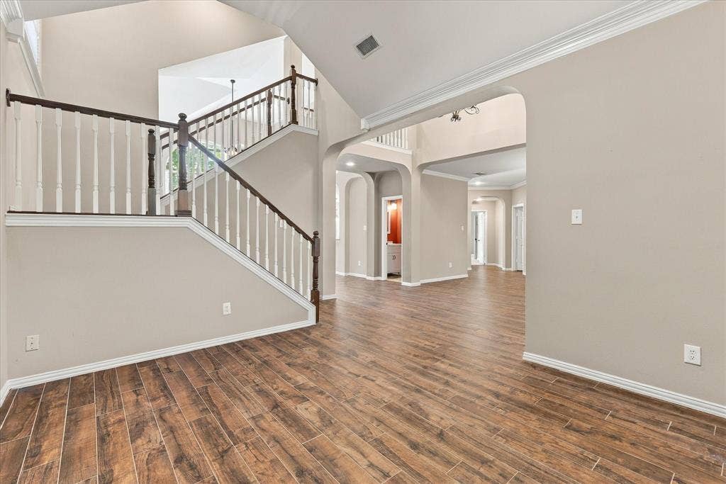 2412 Clearwood Lane, Flower Mound, TX 75028 TIMELESS SOPHISTICATION! A magnificent arched window, graceful crown molding, soaring ceilings, and rich wood-look tile flooring create an elegant, sun-drenched living space. The perfect setting for stylish entertaining, a great home office or a peaceful retreat.
