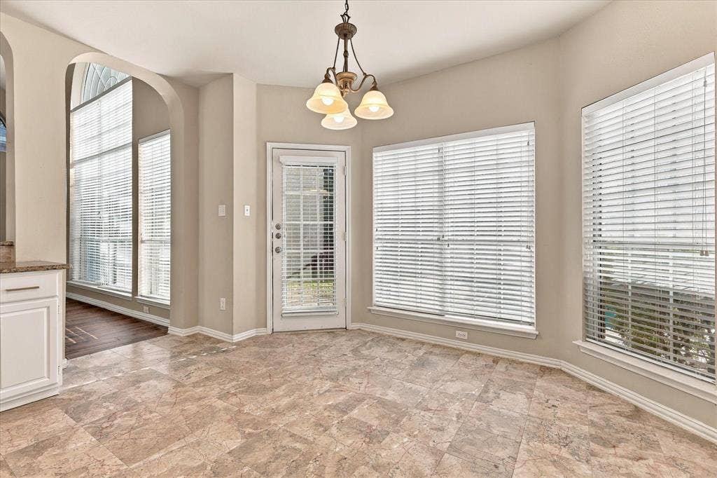 2412 Clearwood Lane, Flower Mound, TX 75028 MORNINGS FEEL A LITTLE MORE MAGICAL HERE! Wrapped in natural light from oversized windows, this charming breakfast nook offers a delightful place to enjoy morning coffee, casual dining, and peaceful views of the outdoors.