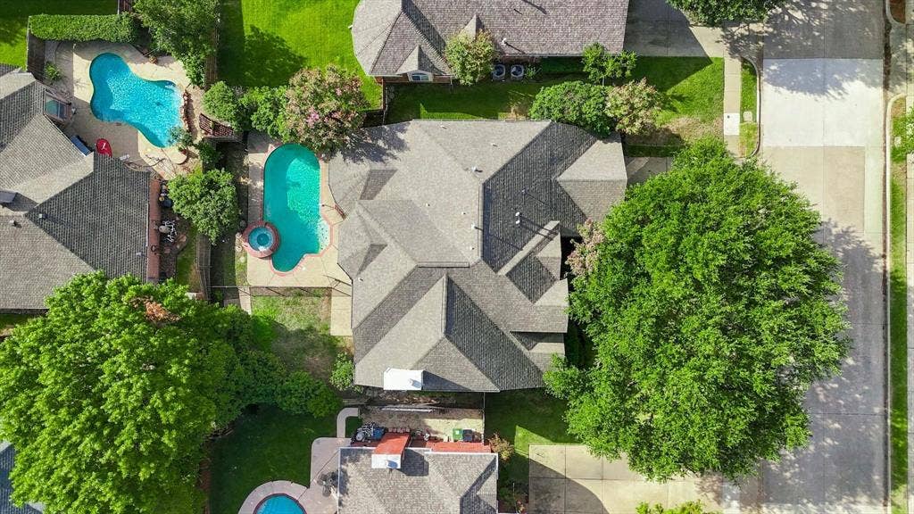 2412 Clearwood Lane, Flower Mound, TX 75028 A bird’s-eye perspective highlights the home’s private backyard oasis, complete with a sparkling pool, spa and a beautifully tucked-away setting within the neighborhood.